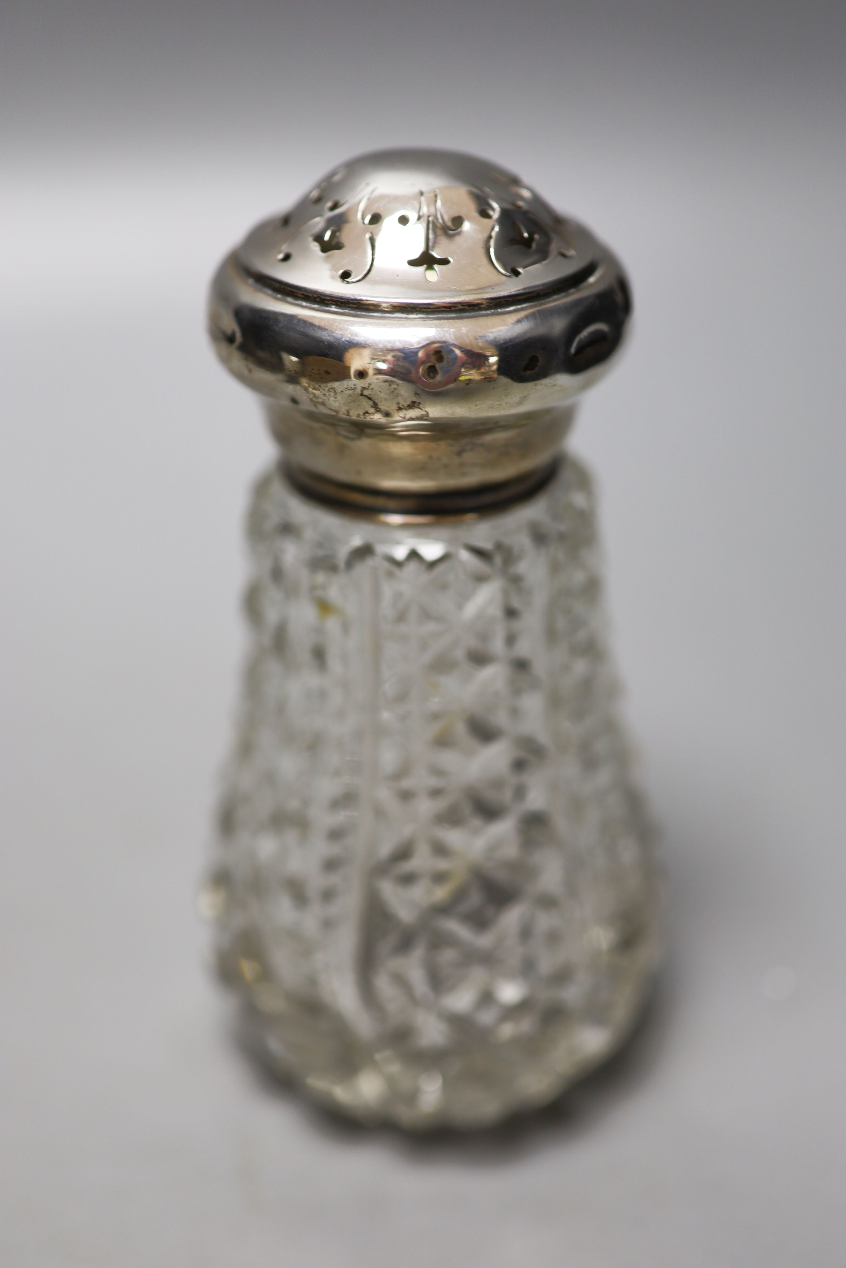 A Victorian silver travelling telescopic cup, Wright & Davis, London, 1881, 89mm, two sugar casters, a mounted glass tidy and a silver mounted salts bottle.